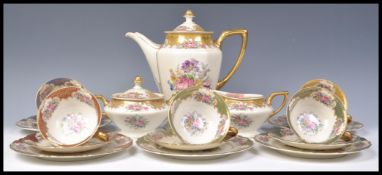 A vintage 20th Century Rosenthal Ivory hand painted tea service consisting of a tall teapot,