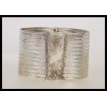 A stamped 900 silver ethnic style bangle bracelet having a rectangular clasp to the front with