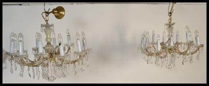 A pair of mid 20th Century twelve / 12 branch light Chandeliers with circular drip pans, baguette