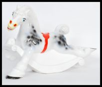 A vintage retro 20th Century ceramic carousel rocking horse figure ornament having a white ground