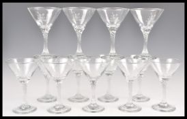 A collection of thirteen vintage retro Babycham glasses having grey etched logos to the bowls and