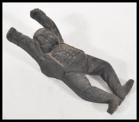 An early 20th Century cast iron boot jack puller in the form of Mr Pickwick doing a handstand.