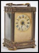 A 19th Century French brass carriage clock having a Roman numeral chapter ring with swing handle