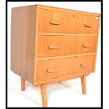 A vintage retro 20th Century Danish inspired teak wood chest of drawers, three long drawers raised