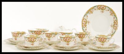 An early 20th Century bone China tea service  by Hughes Fenton, the transfer printed and hand