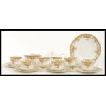 An early 20th Century bone China tea service  by Hughes Fenton, the transfer printed and hand