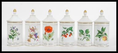 A set of early 20th Century French Limoges porcelain lidded kitchen storage jars of cylindrical form