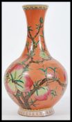 A large 20th Century Chinese hand painted porcelain vase depicting peaches and branches. The vase of