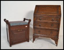 An Edwardian mahogany piano stool with turned handles flanking a hinged and upholstered seat with