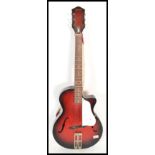 A vintage 20th Century 1950's Egmona six string guitar musical instrument having a flame sunburst