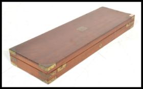 A 19th Century Victorian brass mounted mahogany gun case of rectangular form with square recessed