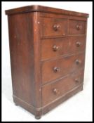 A 19th Century Victorian pine chest of two over three drawers with fitted knob handles raised on bun
