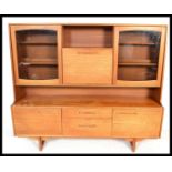 A 1970's Portwood Danish influence highboard sideboard . Raised on tapering legs with a series of