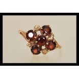 A 9ct gold 19th Century Victorian cluster ring prong set with five round cut garnet's. Ring unmarked