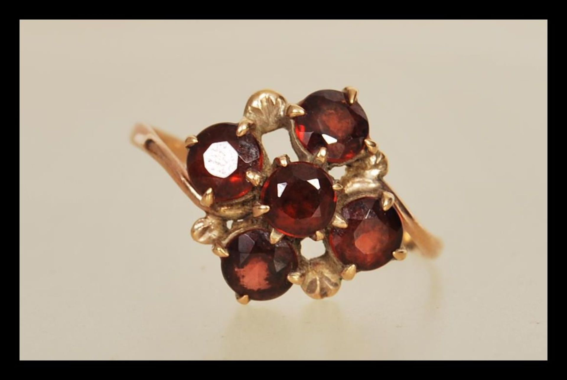 A 9ct gold 19th Century Victorian cluster ring prong set with five round cut garnet's. Ring unmarked