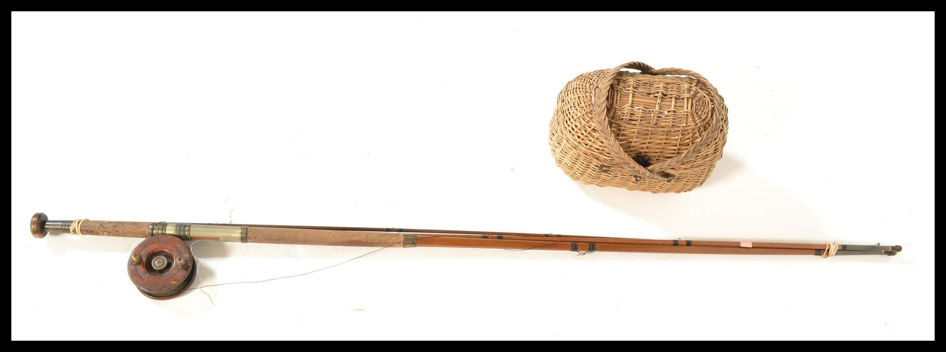 A vintage 20th Century split cane fly fishing rod, together with a vintage wooden and brass fly reel