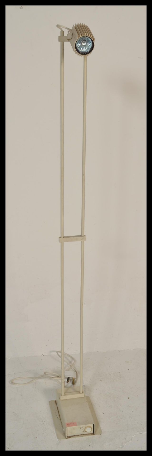 A vintage retro 20th Century floor standing spot lamp raised on a circular base with adjustable lamp