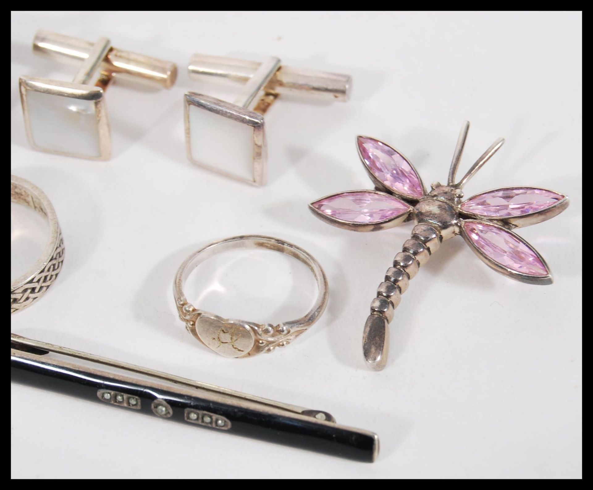 A selection of silver jewellery to include two cross over rings set with black accent stones, a coin - Image 4 of 5