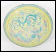 A 20th Century Chinese Famille Jaune ground porcelain plate / bowl having hand painted Famille Verte