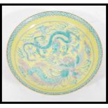 A 20th Century Chinese Famille Jaune ground porcelain plate / bowl having hand painted Famille Verte