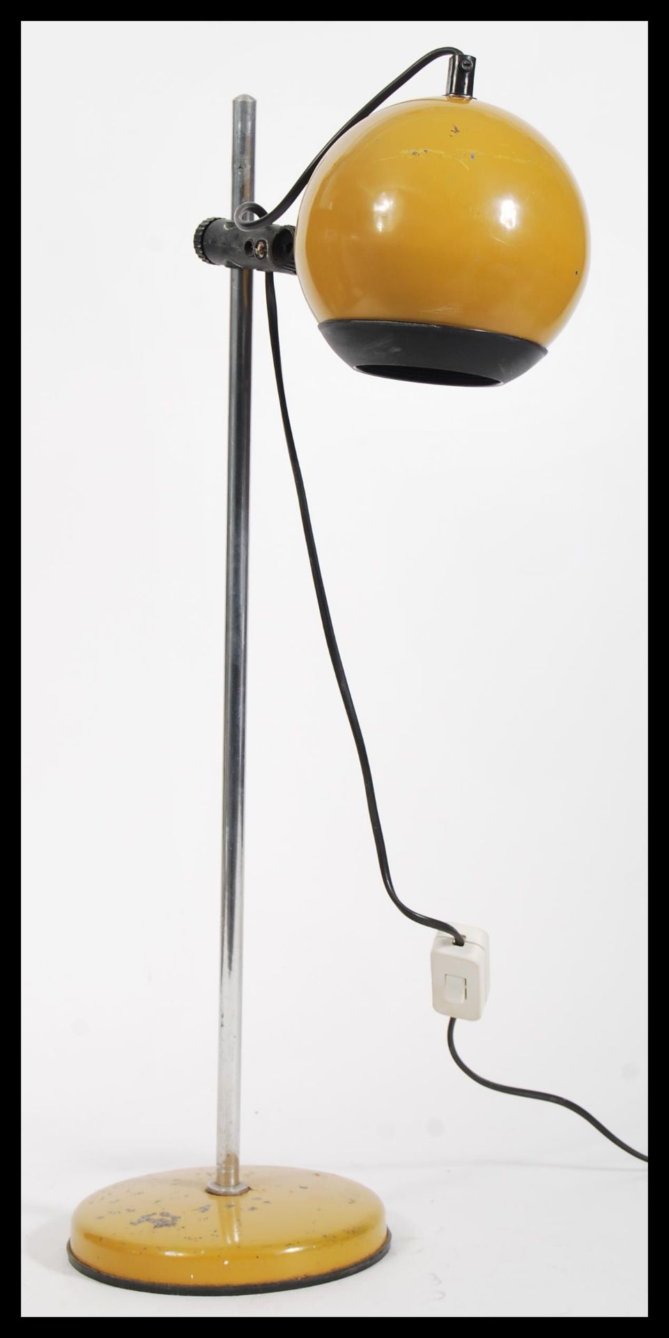 A vintage retro 20th Century Eyeball desk lamp raised on circular base with adjustable tubular