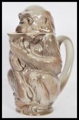 A retro 20th Century West German pitcher jug in the form of a monkey, painted in stone grey with