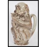 A retro 20th Century West German pitcher jug in the form of a monkey, painted in stone grey with