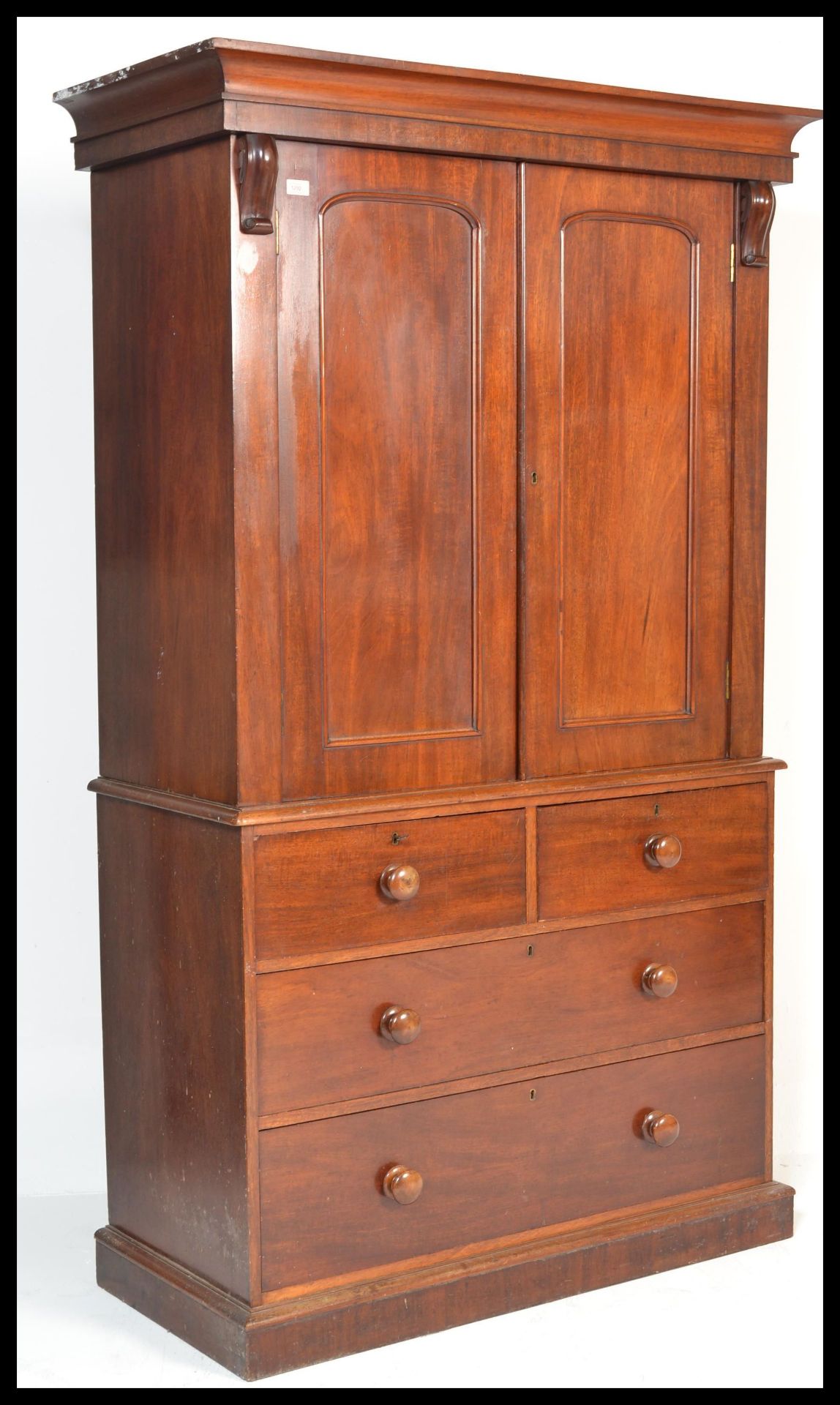 A 19th Century mahogany linen press, moulded cornice over opposing pair of single raised and fielded
