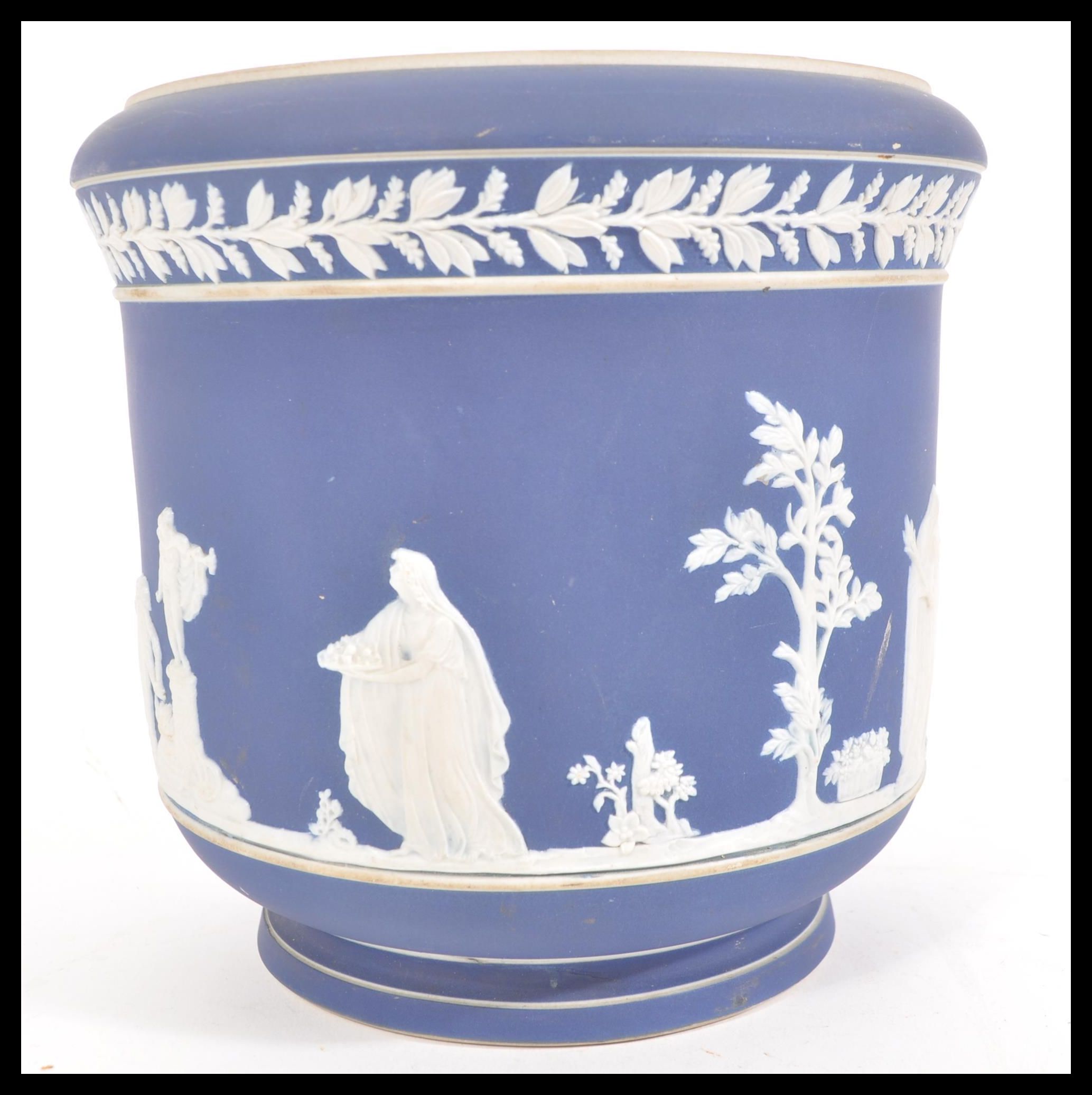 A 19th Century Adams jasperware jardiniere planter, having raised white classical scenes and borders