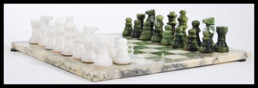A vintage 20th Century Italian Alabaster chess set and board complete in original box appearing