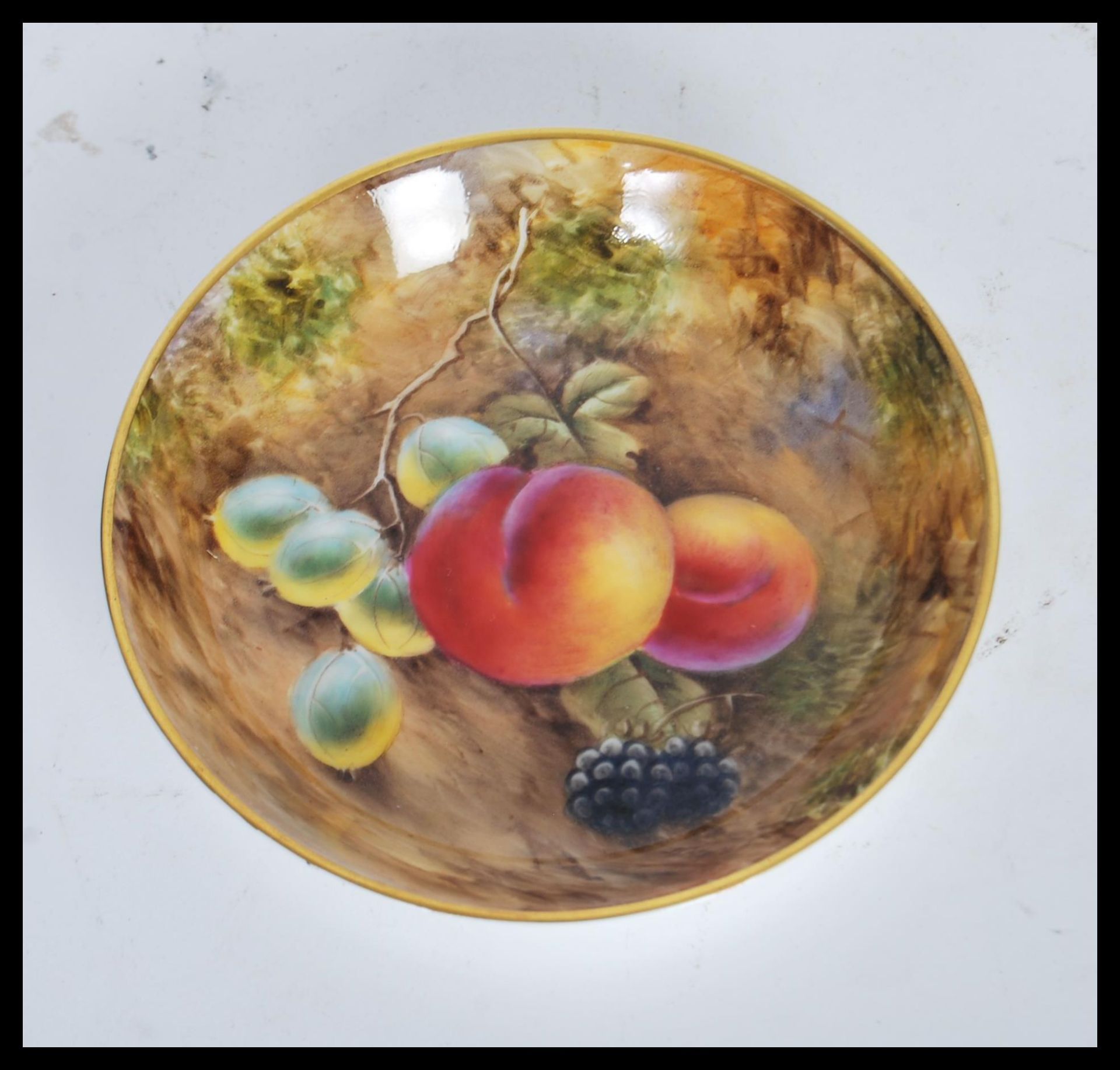 A 20th Century Royal Worcester hand painted cabinet plate painted by J Smith depicting fallen fruit.
