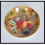 A 20th Century Royal Worcester hand painted cabinet plate painted by J Smith depicting fallen fruit.