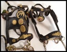 A good group of early 20th Century horse leather tacks and mounts having various horse brasses
