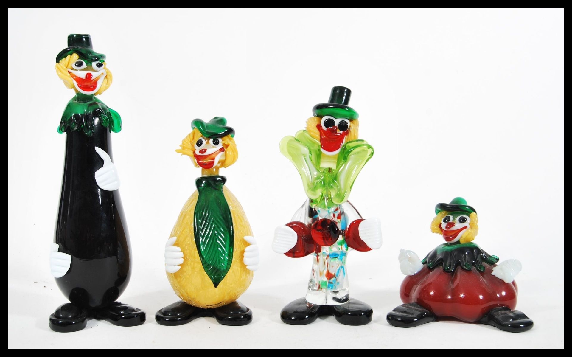 A group of four vintage retro 20th Century Murano studio art glass clowns in the form of fruits to