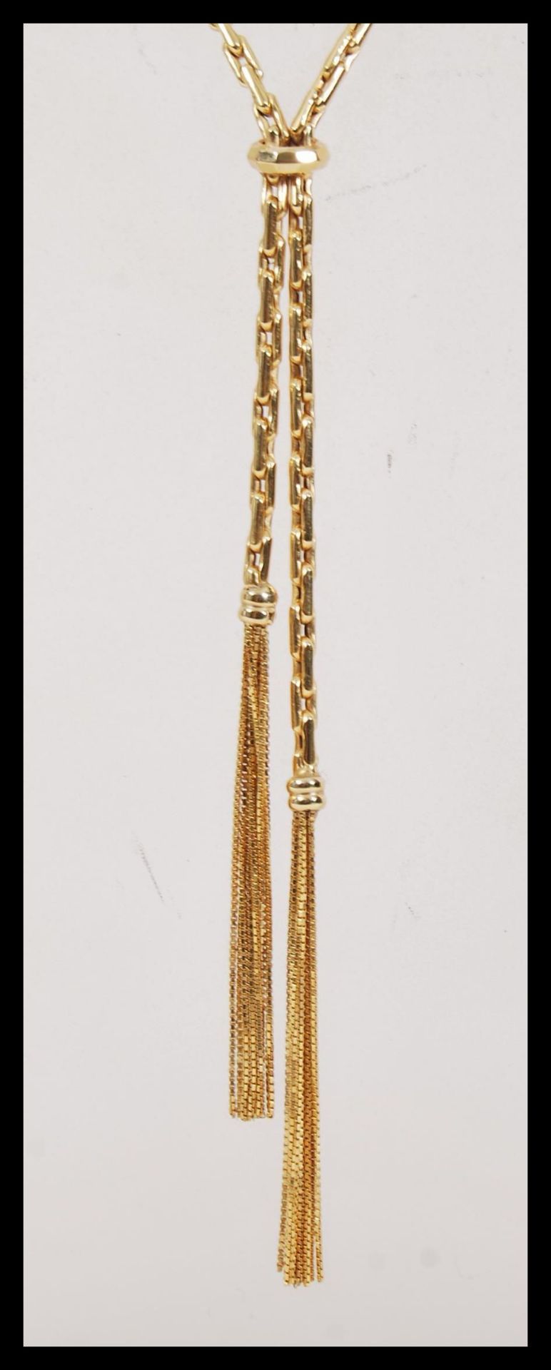 A hallmarked 9ct gold long boxlink necklace chain, having a large bolt ring clasp, with tasseled