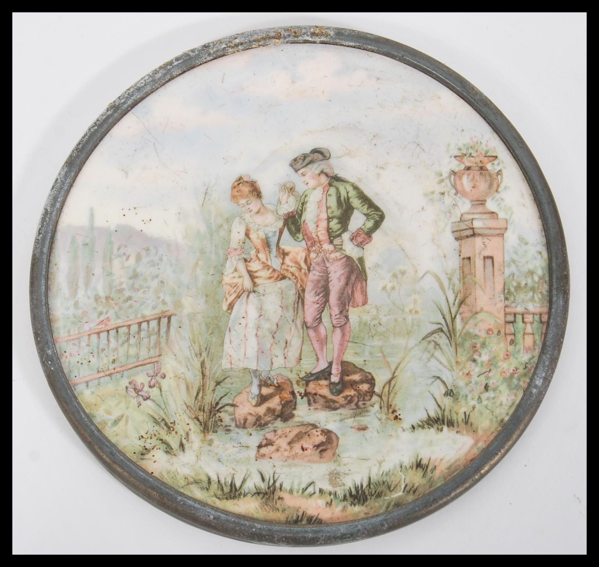 A 19th Century Victorian hand coloured porcelain plaque of circular form depicting a courting couple