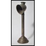 A vintage early 20th Century metal gas students lamp raised on stepped circular base with open