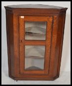 A 19th Century Victorian oak corner cupboard / display cabinet, having a single glazed viewing