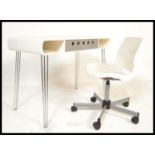 A retro contemporary white desk raised on metal hairpin legs with inset drawer. Complete with