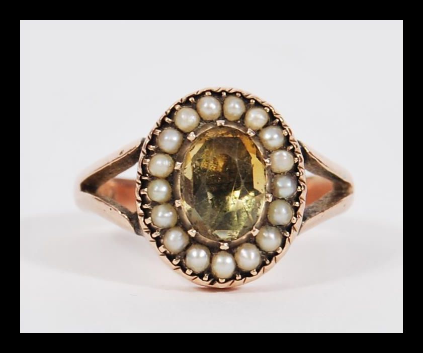 An antique 19th Century Georgian / Victorian 9ct gold seed pearl and citrine ring having a central