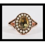 An antique 19th Century Georgian / Victorian 9ct gold seed pearl and citrine ring having a central