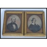 A pair of 19th Century Victorian wet plate photographs of a man and wife set within gilt frames with