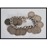 A sixpence coin bracelet on a curb link chain with a heart lock. Lock stamped silver. Gross weight