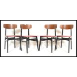 A set of four vintage retro 20th Century dining chairs in the manner of G Plan raised on ebonised