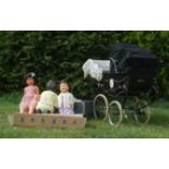 A 20th Century Silver Cross dolls pram painted black having a black canape. Along with three