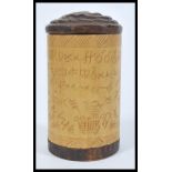 An early 20th Century Aboriginal tribal hand carved wooden cylindrical pot having Aboriginal
