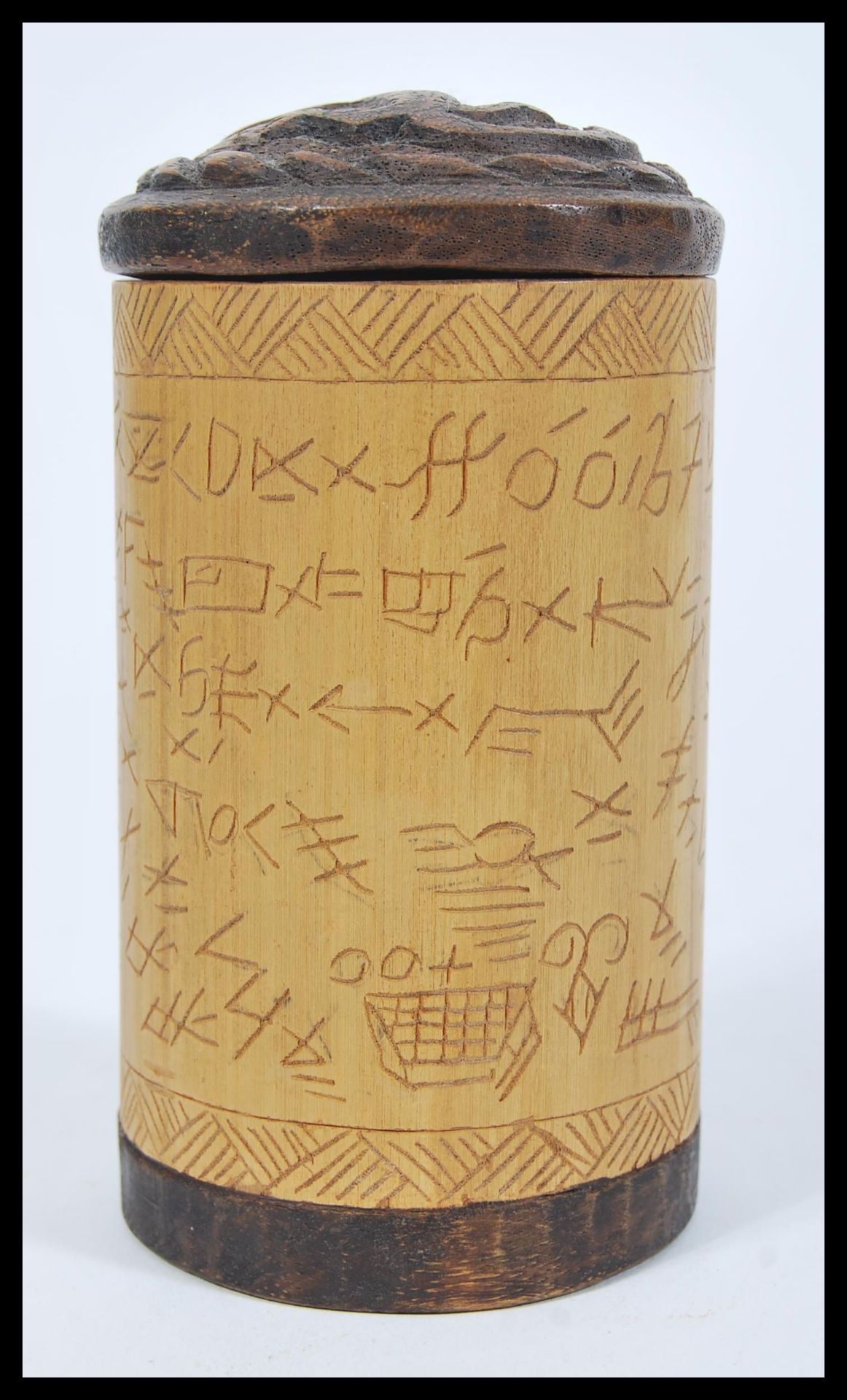 An early 20th Century Aboriginal tribal hand carved wooden cylindrical pot having Aboriginal