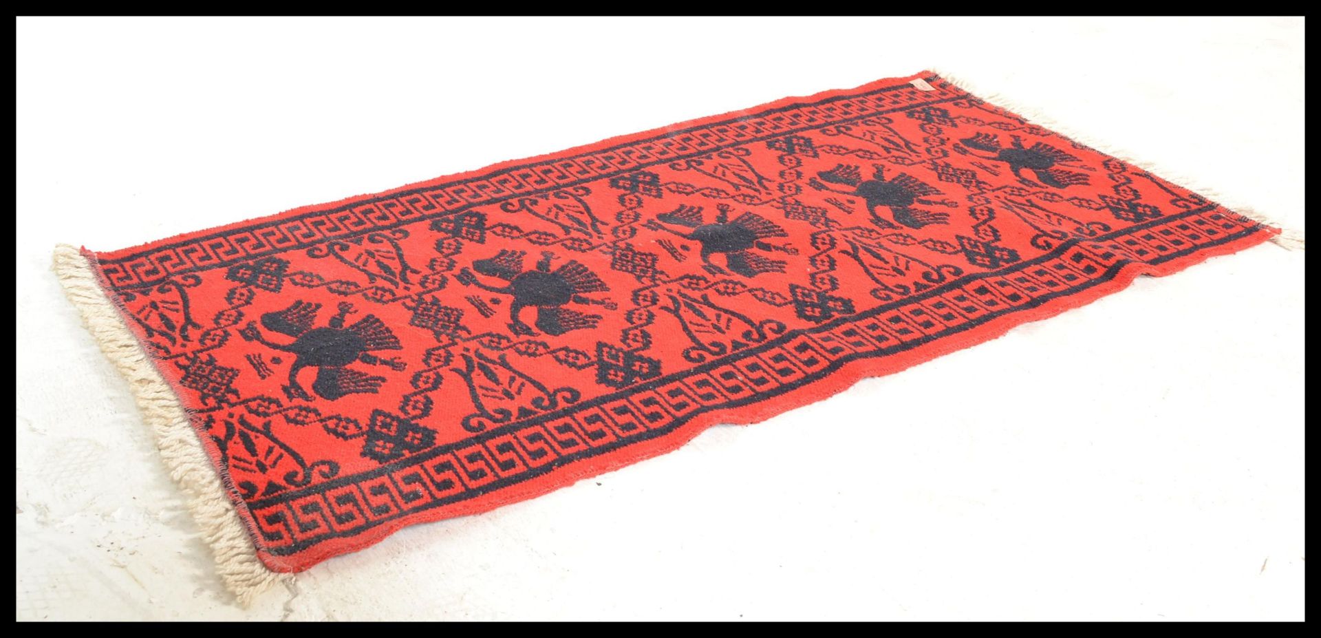 A vintage 20th Century Eastern European Russian / Albanian floor carpet rug having a red ground with - Bild 2 aus 3