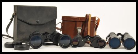 A group of vintage binoculars to include a pair of Russian Cold War CCCP binoculars 8x30, Regent