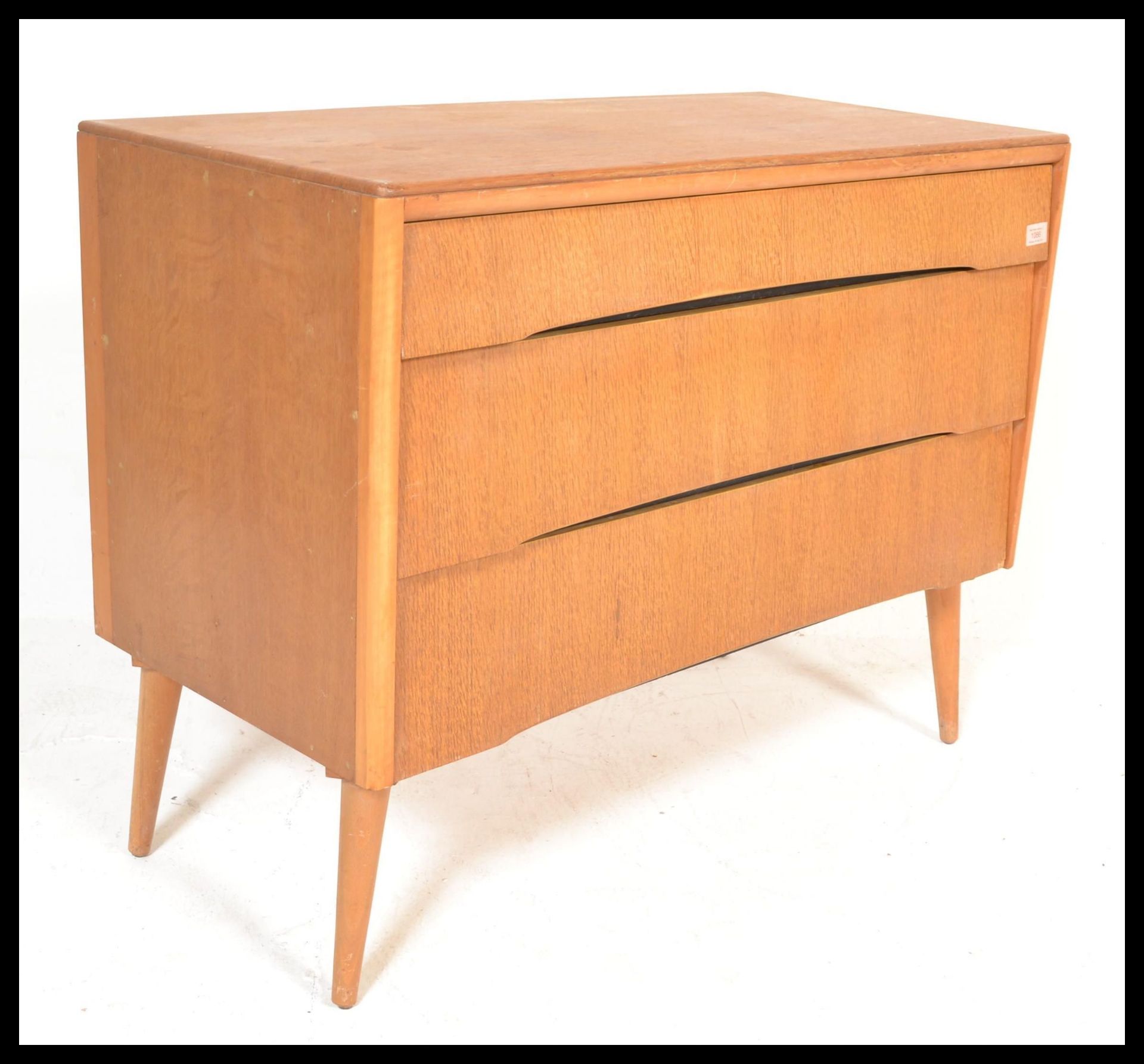 A vintage retro mid 20th Century teak wood Beehive fronted chest of drawers having a bank of three